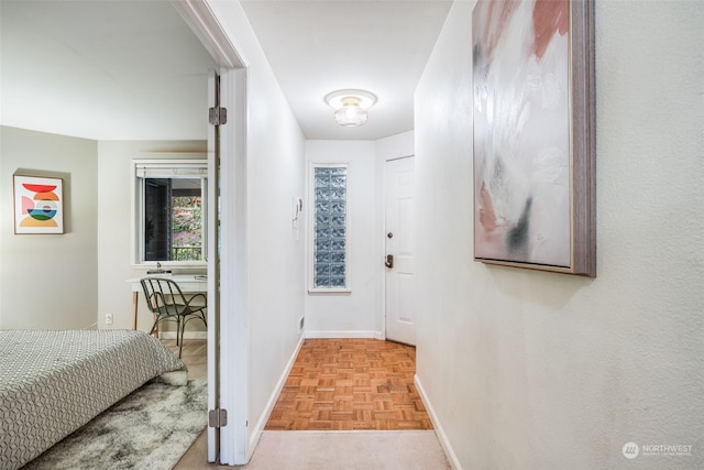 hallway featuring light parquet flooring