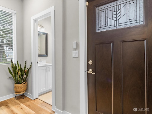 foyer featuring a wealth of natural light and light hardwood / wood-style flooring