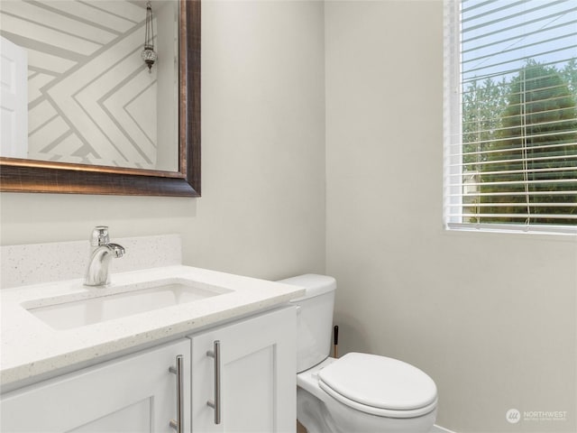 bathroom featuring vanity and toilet