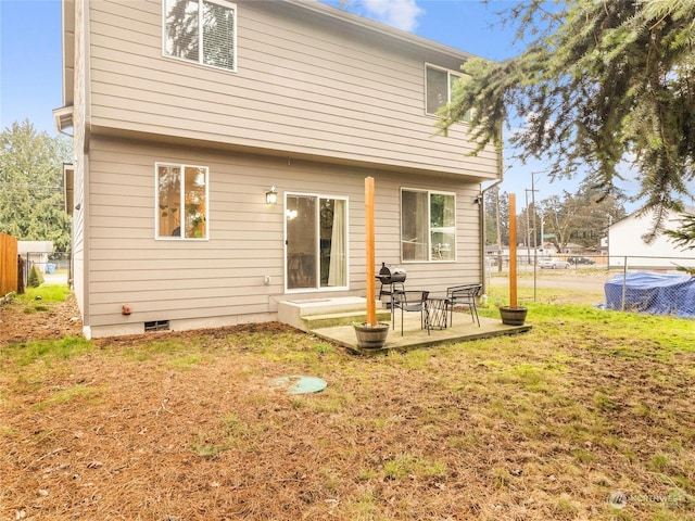 rear view of property with a lawn and a patio