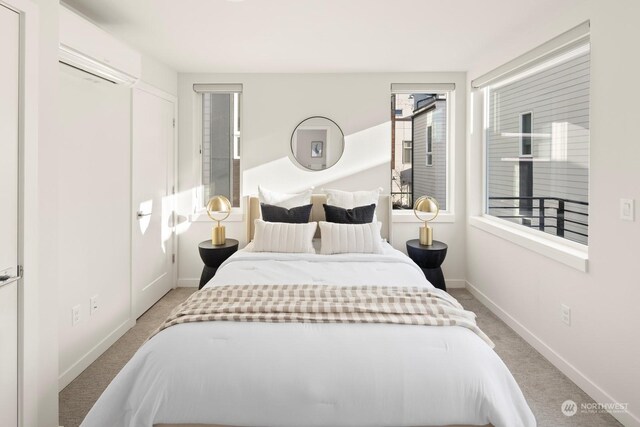 carpeted bedroom featuring an AC wall unit