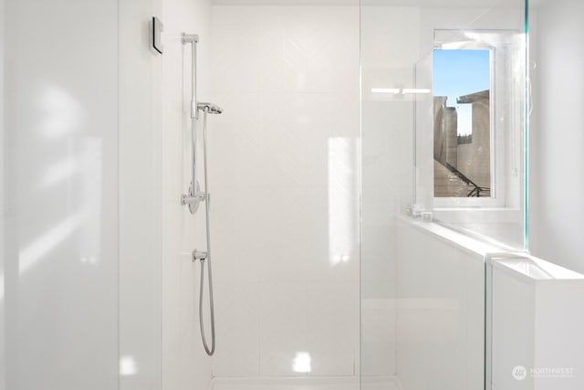 bathroom with tiled shower