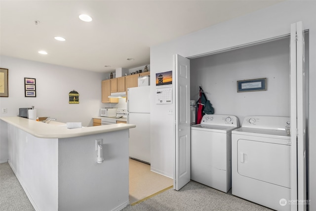 clothes washing area with light carpet and washer and clothes dryer