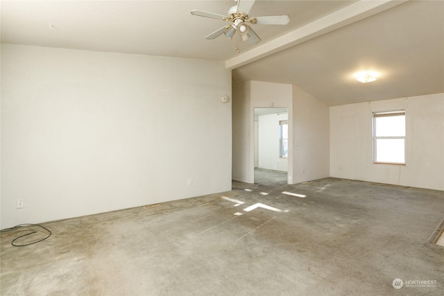 carpeted empty room featuring ceiling fan and lofted ceiling with beams