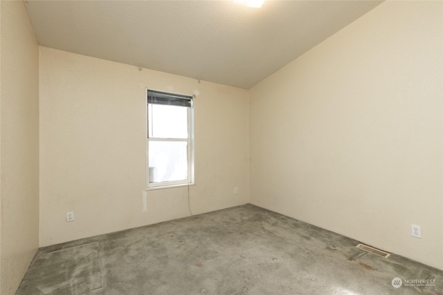 carpeted spare room featuring lofted ceiling