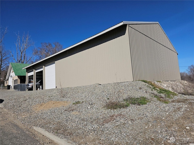 view of home's exterior with a garage and an outdoor structure