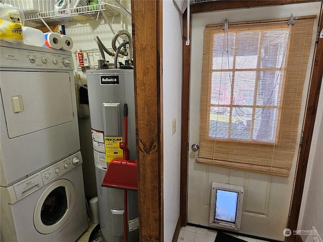 clothes washing area featuring water heater and stacked washer and dryer