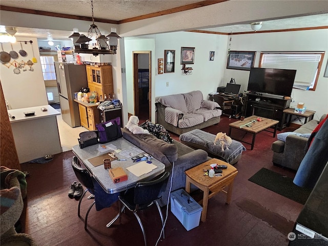 living room with crown molding, hardwood / wood-style flooring, and a textured ceiling