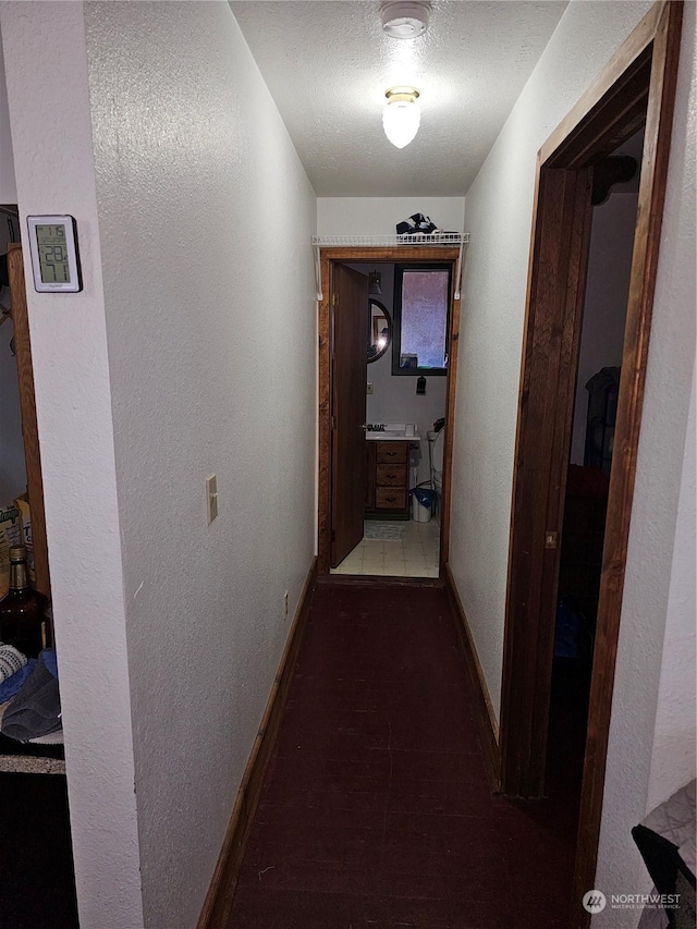 hallway with a textured ceiling