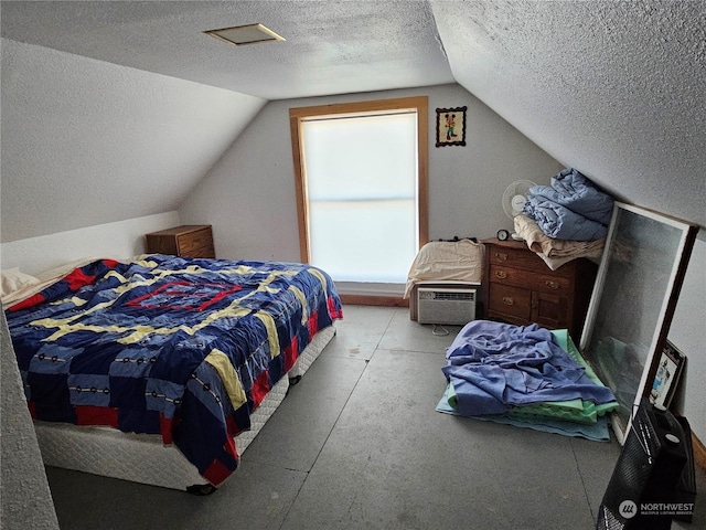 bedroom with vaulted ceiling and a textured ceiling