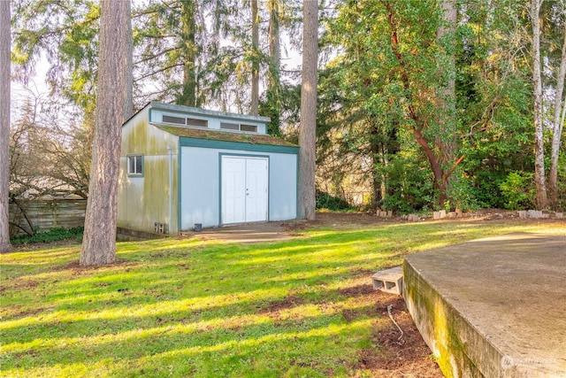 view of outdoor structure featuring a lawn