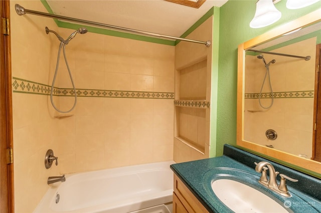 bathroom featuring vanity and tiled shower / bath