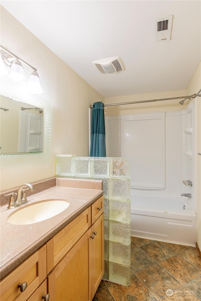 bathroom featuring shower / tub combo and vanity