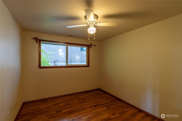 spare room with dark hardwood / wood-style floors and ceiling fan