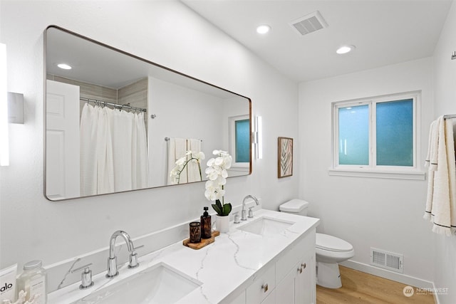 bathroom featuring hardwood / wood-style flooring, vanity, toilet, and a shower with shower curtain