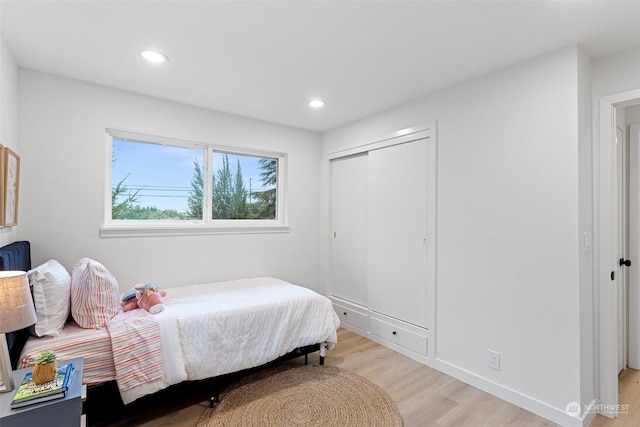 bedroom featuring light hardwood / wood-style floors and a closet