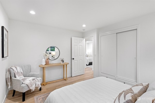 bedroom featuring hardwood / wood-style floors and a closet