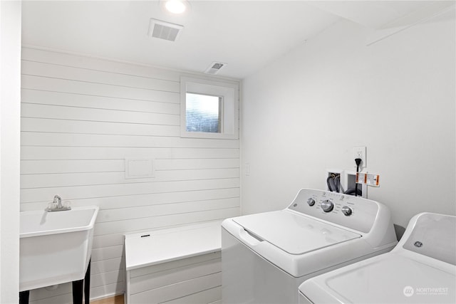 washroom with sink and washer and dryer