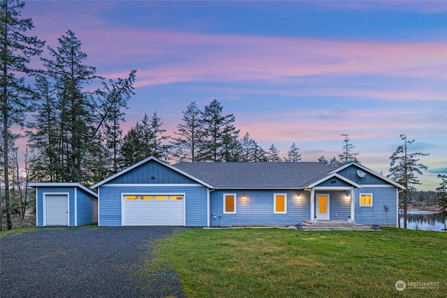 view of front of home featuring a yard and a garage