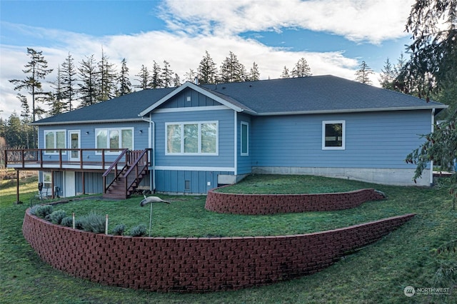 rear view of property with a lawn and a deck