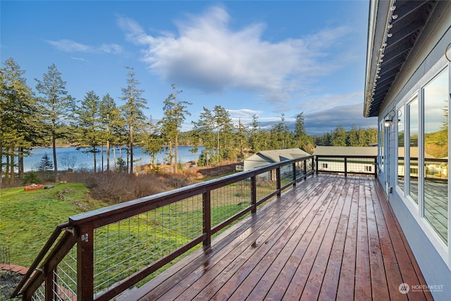 wooden terrace with a lawn and a water view