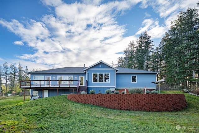 back of house with a lawn and a deck