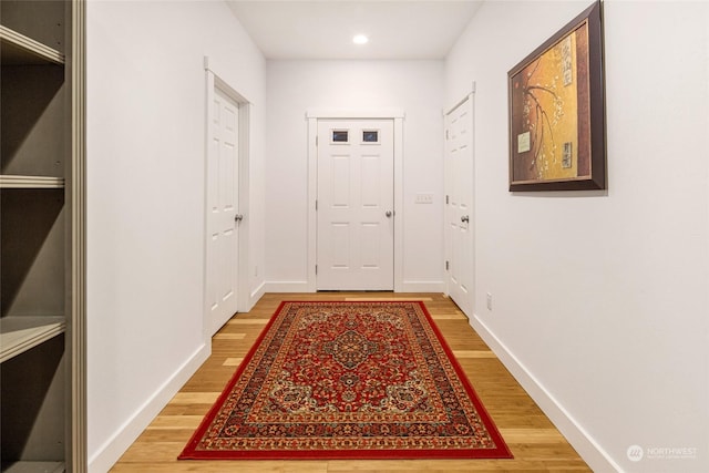 doorway with hardwood / wood-style flooring