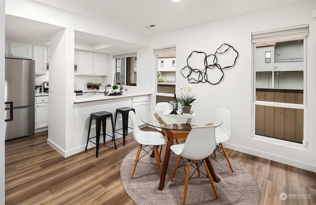 dining space featuring dark hardwood / wood-style floors