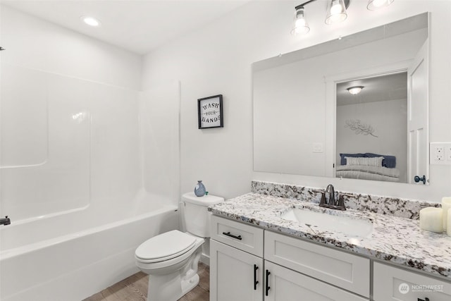 full bathroom with wood-type flooring, bathtub / shower combination, vanity, and toilet