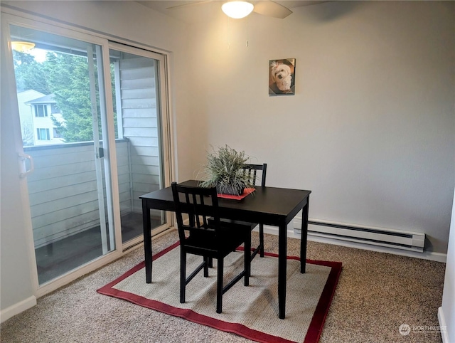 carpeted dining room with baseboard heating and ceiling fan