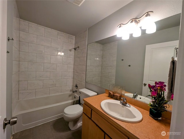 full bathroom featuring tile patterned floors, vanity, toilet, and tiled shower / bath