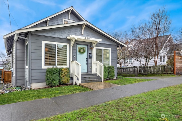 bungalow-style home featuring a front yard