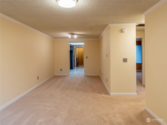 carpeted spare room featuring crown molding and a textured ceiling