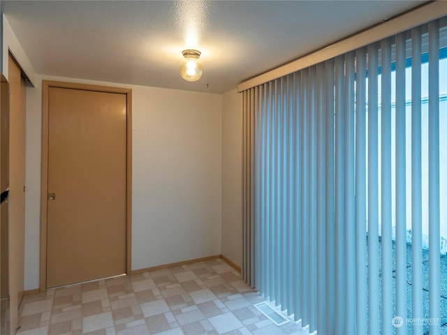 empty room with a textured ceiling