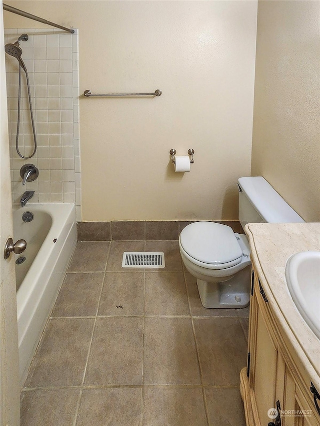 full bathroom featuring vanity, toilet, and tiled shower / bath combo