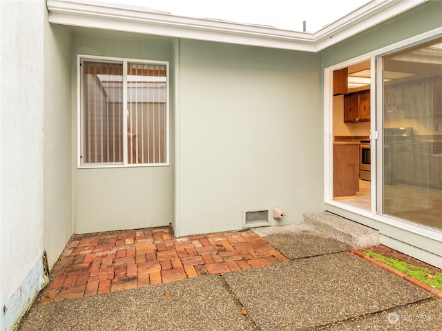 entrance to property with a patio