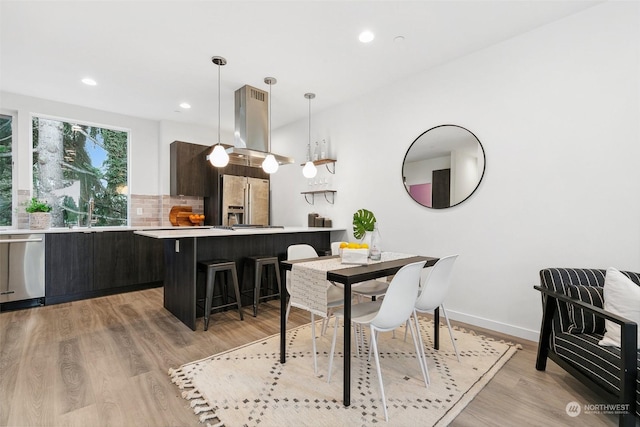 dining space featuring light hardwood / wood-style flooring and sink