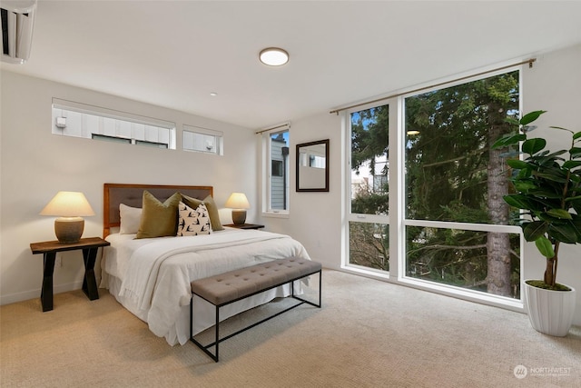 bedroom with light colored carpet and a wall mounted AC