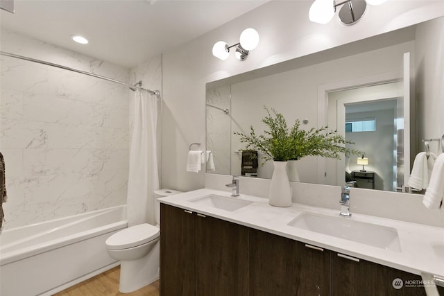 full bathroom with hardwood / wood-style flooring, shower / bath combination with curtain, toilet, and vanity