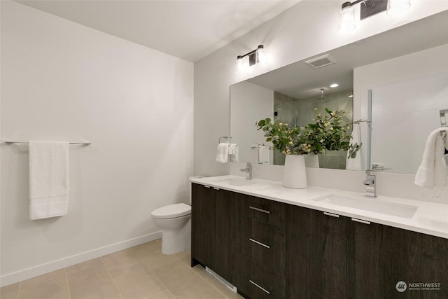 bathroom featuring tile patterned flooring, toilet, vanity, and walk in shower