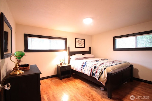 bedroom with light wood-type flooring and baseboards