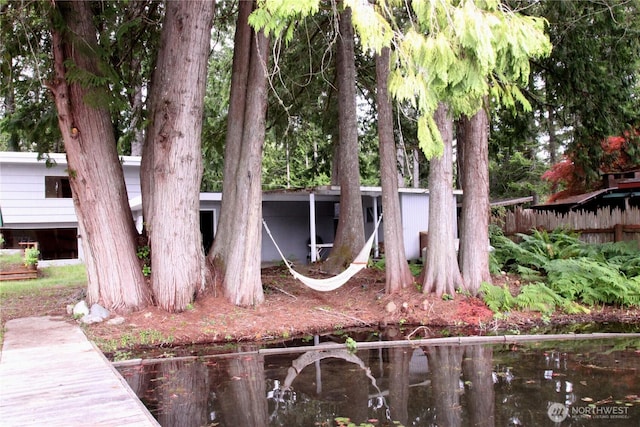 rear view of house featuring fence