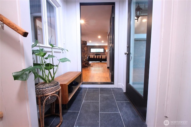 hallway with dark tile patterned floors