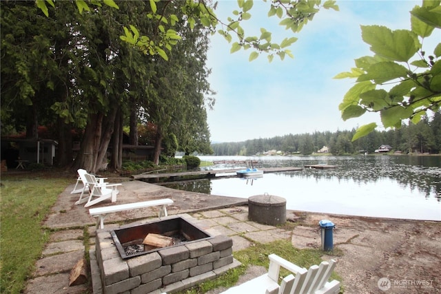 view of patio featuring a water view and a fire pit