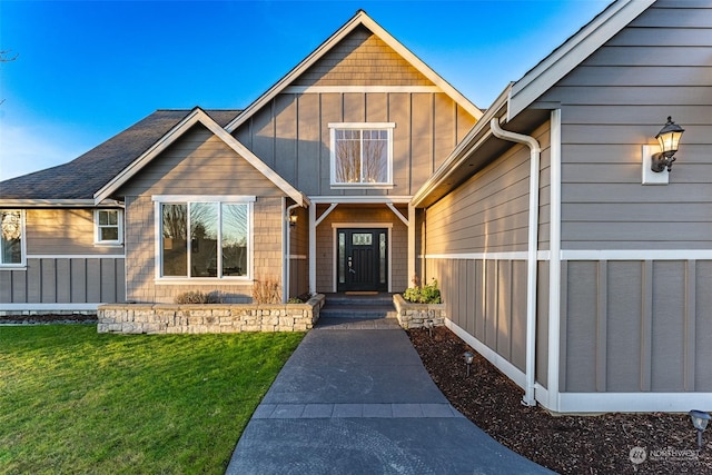 property entrance with a lawn