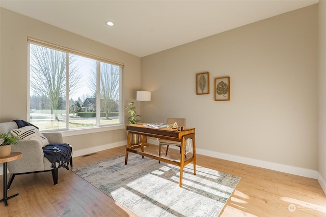 home office featuring plenty of natural light and light hardwood / wood-style floors