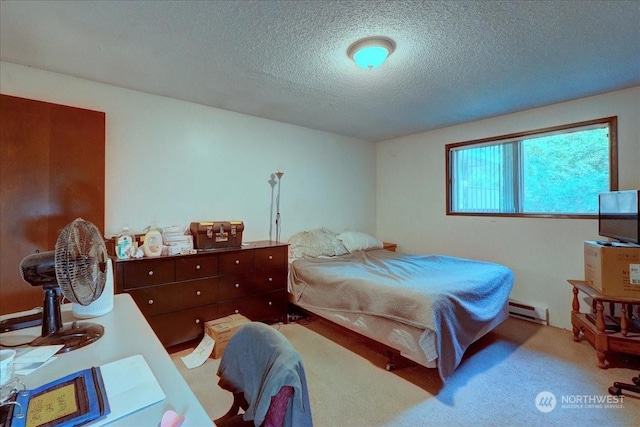 carpeted bedroom featuring a textured ceiling and a baseboard heating unit