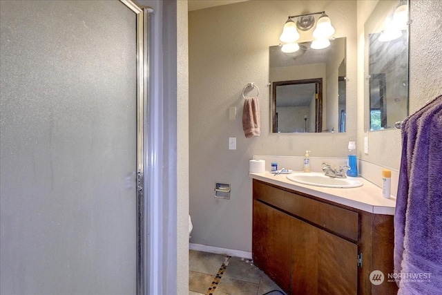 bathroom with tile patterned flooring, vanity, and a shower with shower door