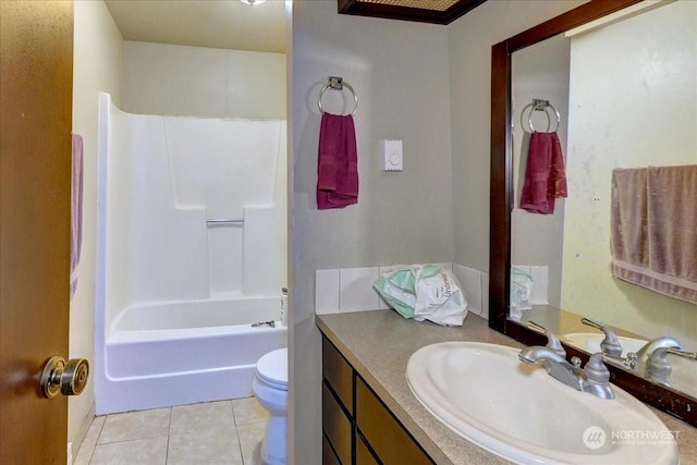 bathroom with toilet,  shower combination, vanity, and tile patterned flooring