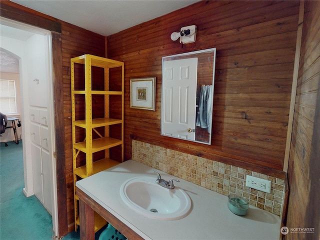 bathroom with wooden walls and vanity